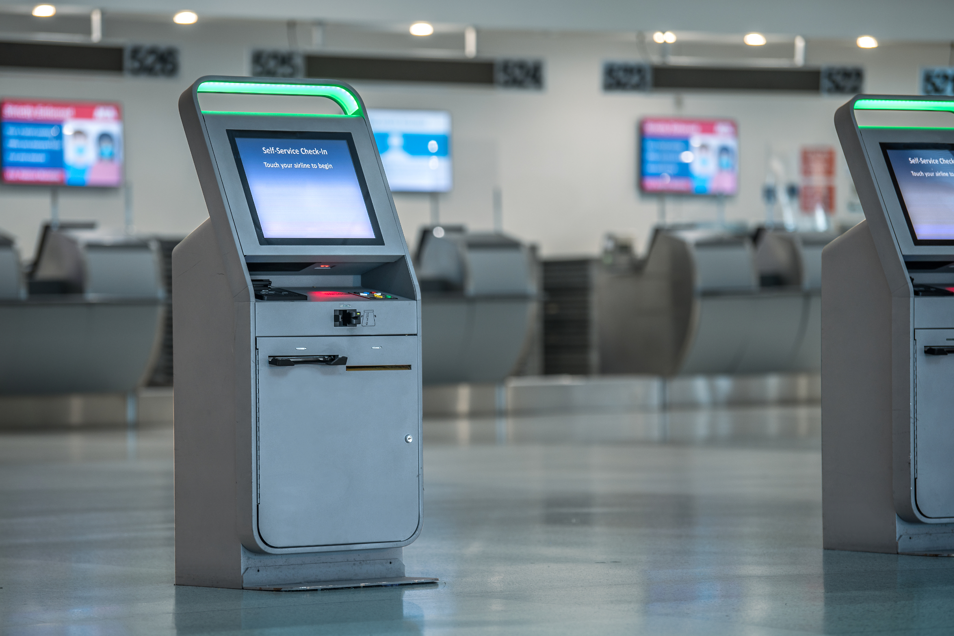 An accesiible self check-in kiosk inside an airport terminal.
