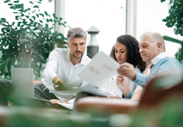 A group of people talking in an office