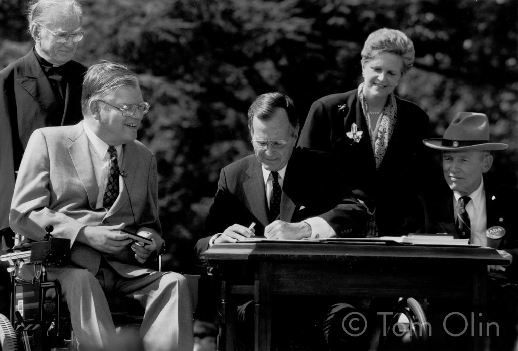 A photo by Tom Olin of the ADA signing featuring President George H. W. Bush.