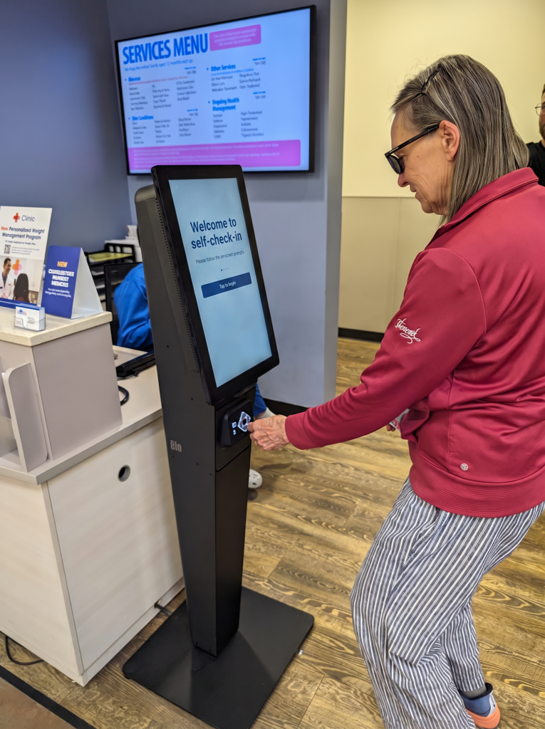 A visually impaired person using an accessible kiosk.